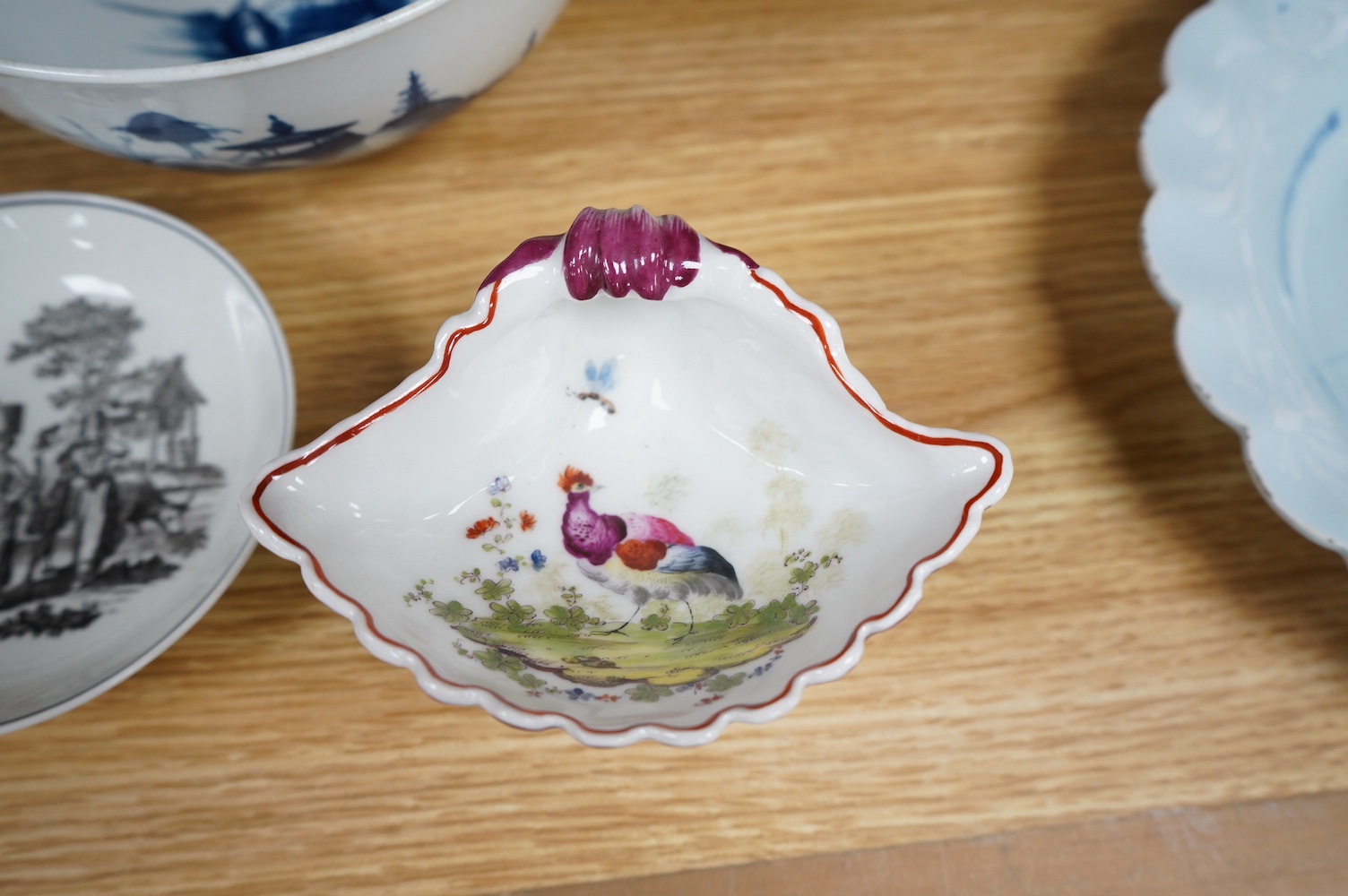 A Worcester coffee cup and saucer, Milkmaid pattern by Hancock, a pair of English porcelain shell salts, and a Worcester blue and white bowl, 18cm (5). Condition - fair